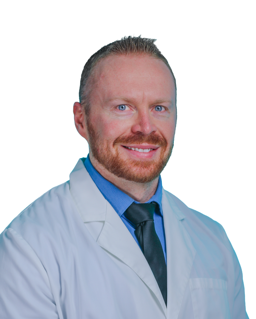 Smiling male doctor in a white lab coat, blue shirt, and tie, facing the camera against a black background