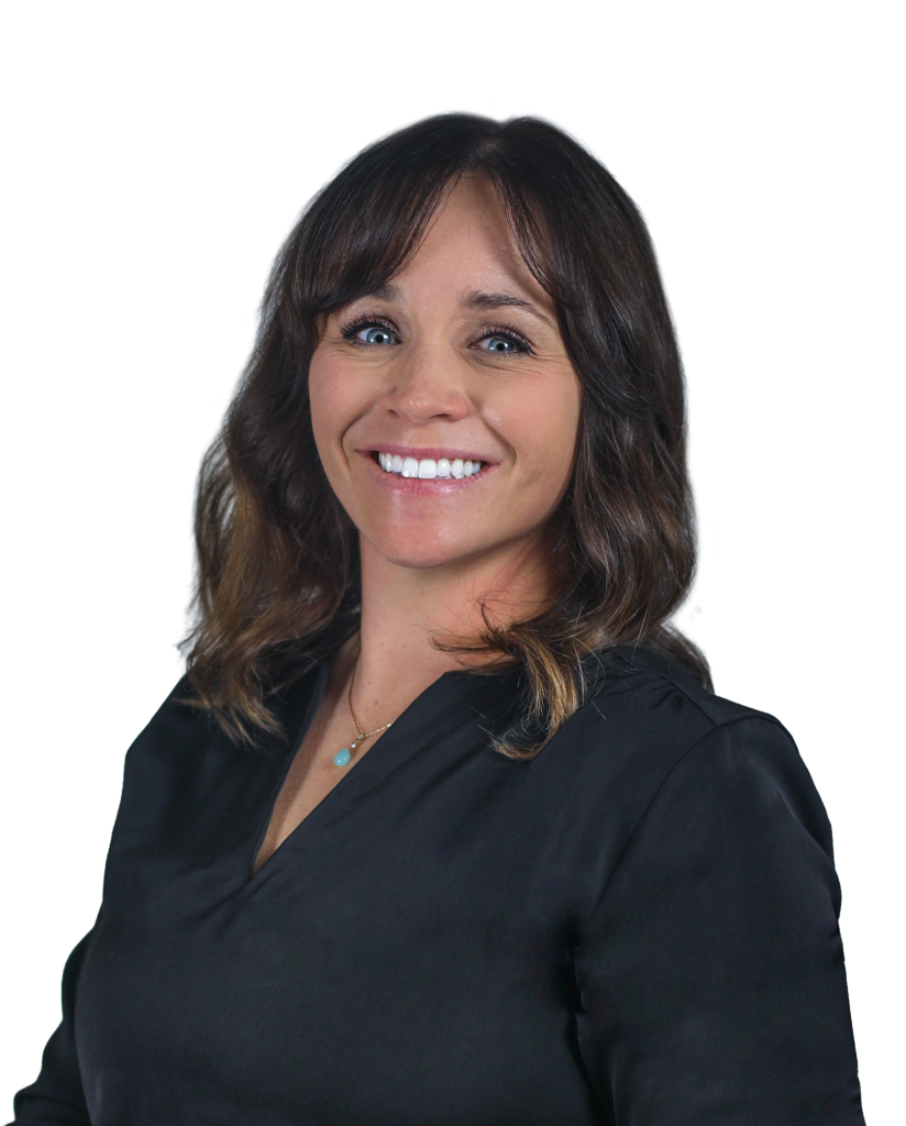 Smiling woman with shoulder-length dark hair and blue eyes, wearing a black blouse and turquoise pendant.