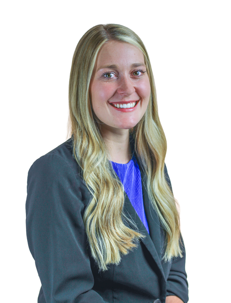 Portrait of a smiling woman with long blonde hair, wearing a dark blazer and a blue top, cropped to show head and shoulders.
